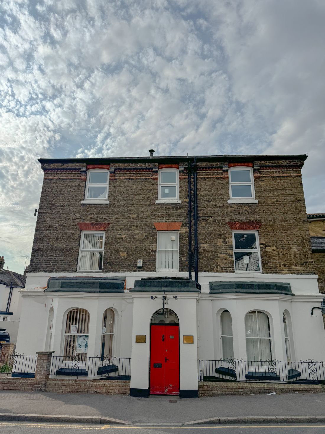 The Sedgemead House clinic, a period building on Beaconsfield Road, Dover, with a red front door.